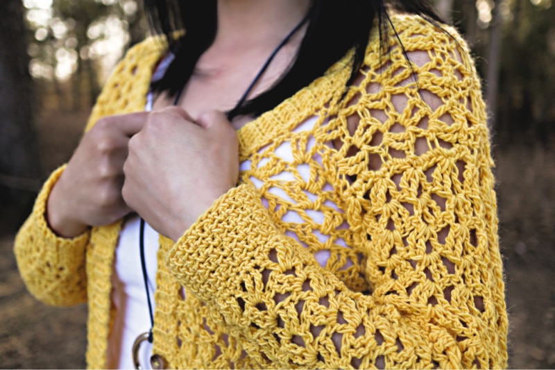 Close up photo of the sleeves on the Addy Lace Cardigan crochet pattern.