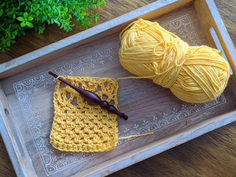 A gauge swatch for the Addy Lace Cardigan using whims merino and an Alpha Series crochet hook.