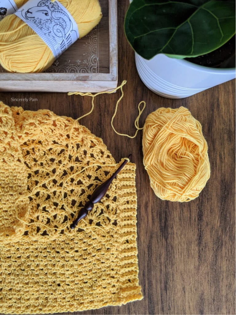 The ribbed band and button holes are being crocheted directly onto the front panel of the Addy Lace cardigan.